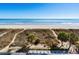 Scenic beach view from a balcony with ocean and dunes, showcasing the resort's stunning coastal location and amenities at 4619 S Ocean Blvd. # 501, North Myrtle Beach, SC 29582