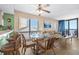 Cozy dining area featuring a glass table, wicker chairs, and a view of the ocean from a large window at 4619 S Ocean Blvd. # 501, North Myrtle Beach, SC 29582