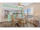 Intimate dining area with a glass table and wicker chairs, adjacent to a kitchen and featuring a scenic view at 4619 S Ocean Blvd. # 501, North Myrtle Beach, SC 29582