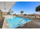 Outdoor pool features a gated area and palm trees with a row of lounge chairs and stairs at 4619 S Ocean Blvd. # 501, North Myrtle Beach, SC 29582