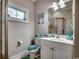 Neutral tone bathroom with a glass door shower and white vanity with beach-themed decor at 4762 Cloister Ln., Myrtle Beach, SC 29577