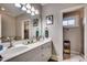 Bright bathroom featuring double sinks, a large mirror, vanity with drawers, and tile flooring at 4762 Cloister Ln., Myrtle Beach, SC 29577