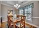 Formal dining area with wood table and chairs, chandelier lighting, and natural light at 4762 Cloister Ln., Myrtle Beach, SC 29577