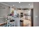 Bright kitchen featuring white cabinets, stainless steel appliances, bar seating and wood flooring at 4762 Cloister Ln., Myrtle Beach, SC 29577