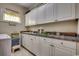 Functional laundry room with white cabinets and gray countertops at 4762 Cloister Ln., Myrtle Beach, SC 29577