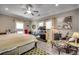 Spacious main bedroom with a ceiling fan, carpet, and generous natural light at 4762 Cloister Ln., Myrtle Beach, SC 29577