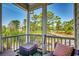 Relaxing screened porch with chairs and table, views of the surrounding landscape at 4762 Cloister Ln., Myrtle Beach, SC 29577