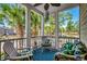 Relaxing screened porch with chairs and tropical decorations, views of the surrounding landscape at 4762 Cloister Ln., Myrtle Beach, SC 29577