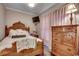 Cozy bedroom with a wooden bed frame, dresser, and soft lighting at 4762 Cloisters Ln., Myrtle Beach, SC 29577