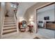 Welcoming foyer with staircase, tiled flooring, and a view into the adjacent dining area at 4762 Cloisters Ln., Myrtle Beach, SC 29577