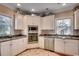 Well-lit kitchen equipped with stainless steel appliances, white cabinetry, and stylish countertops at 4762 Cloisters Ln., Myrtle Beach, SC 29577