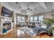 Bright living room featuring a fireplace, hardwood floors, and a tray ceiling with fan at 4762 Cloisters Ln., Myrtle Beach, SC 29577