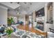 Open concept living room with hardwood floors, fireplace, and seamless flow to adjacent dining area at 4762 Cloisters Ln., Myrtle Beach, SC 29577