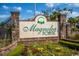 Beautifully landscaped entrance sign for Magnolia Pointe community with vibrant flowerbeds and brick accents at 4889 Magnolia Pointe Ln. # 105, Myrtle Beach, SC 29577