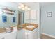 Well-lit bathroom featuring a single sink, decorative mirror, and neutral wall color at 501 Maison Dr. # F15, Myrtle Beach, SC 29572