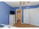 Blue bedroom with a large closet, television, and a connected full bathroom at 501 Maison Dr. # F15, Myrtle Beach, SC 29572