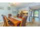 Cozy dining room with wood table, seating for six, and view into the kitchen at 501 Maison Dr. # F15, Myrtle Beach, SC 29572