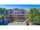 Exterior view of a multi-level condo complex with parking spaces, landscaping, and stairs leading to each level at 501 Maison Dr. # F15, Myrtle Beach, SC 29572