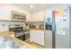 Efficient kitchen featuring white cabinetry, stainless steel appliances, and tile backsplash at 501 Maison Dr. # F15, Myrtle Beach, SC 29572