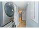 Convenient laundry area with front load washer and dryer in a bright hallway at 501 Maison Dr. # F15, Myrtle Beach, SC 29572