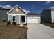 Charming single-story home with vinyl siding and a two-car garage on a sunny day at 516 Tillage Ct., Conway, SC 29526