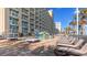 Outdoor pool area with lounge chairs and tropical trees at 5200 N Ocean Blvd. # Ph36, Myrtle Beach, SC 29577