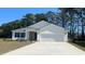 Charming single-story home features a two-car garage, manicured lawn, and lovely landscaping at 522 Haven View Way, Murrells Inlet, SC 29576