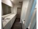 Bathroom featuring a long countertop, a mirror, white cabinets and trim, and vinyl floors at 536 Tillage Ct., Conway, SC 29526