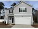 Two-story home featuring a two-car garage, gray siding, black shutters, and a well-manicured lawn at 536 Tillage Ct., Conway, SC 29526