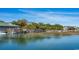 Beautiful waterfront view of buildings, boats, and pier on a sunny day at 542 Haven View Way, Murrells Inlet, SC 29576