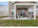 Covered back patio with outdoor seating and a grill, perfect for entertaining at 5519 Redleaf Rose Dr., Myrtle Beach, SC 29579