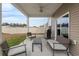 Covered back patio with outdoor seating, grill, and view of the fenced yard at 5519 Redleaf Rose Dr., Myrtle Beach, SC 29579