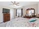 Bright bedroom featuring a ceiling fan, dresser, and window with blinds at 5519 Redleaf Rose Dr., Myrtle Beach, SC 29579