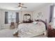 Bedroom with bright window and carpet featuring an antique bed frame and wooden mirror at 5519 Redleaf Rose Dr., Myrtle Beach, SC 29579