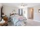 Bedroom with bright window and carpet featuring an antique bed frame and wooden mirror at 5519 Redleaf Rose Dr., Myrtle Beach, SC 29579