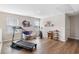 Well-lit bonus room with hardwood floors, exercise equipment and natural light from bright windows at 5519 Redleaf Rose Dr., Myrtle Beach, SC 29579