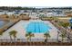 Aerial view of a community pool with palm trees and ample seating at 5519 Redleaf Rose Dr., Myrtle Beach, SC 29579