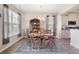 Charming dining room with a classic wooden table, blue rug, and ample natural light at 5519 Redleaf Rose Dr., Myrtle Beach, SC 29579