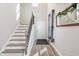 Well-lit entryway highlighting wood-look floors, stairs, and a view of the front door at 5519 Redleaf Rose Dr., Myrtle Beach, SC 29579