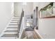 Bright entryway featuring wood-look floors, a staircase, and a front door with a decorative wreath at 5519 Redleaf Rose Dr., Myrtle Beach, SC 29579