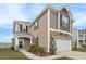 Attractive home showcasing a blend of siding and stone, with a two-car garage and tidy landscaping at 5519 Redleaf Rose Dr., Myrtle Beach, SC 29579