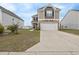 Two-story home with stone and siding accents, featuring a two-car garage and a large driveway at 5519 Redleaf Rose Dr., Myrtle Beach, SC 29579