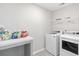 Functional laundry room with a counter, shelving, washer and dryer at 5519 Redleaf Rose Dr., Myrtle Beach, SC 29579