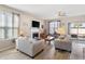 Well-lit living room featuring a fireplace, comfortable seating, and access to the outdoor patio at 5519 Redleaf Rose Dr., Myrtle Beach, SC 29579