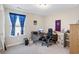 Functional home office with carpet, a window, desk, chair, and fan decorations at 5519 Redleaf Rose Dr., Myrtle Beach, SC 29579