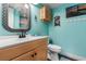 Charming bathroom with blue walls, wooden vanity, and coastal-themed decorations at 5905 South Kings Hwy. # 6215D, Myrtle Beach, SC 29575