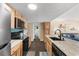 Cozy kitchen with black appliances, knotty wood cabinets, island, and an adjacent living room view at 5905 South Kings Hwy. # 6215D, Myrtle Beach, SC 29575