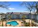 Aerial view of a community pool surrounded by condos, palm trees, and lounge chairs at 5905 South Kings Hwy. # 6215D, Myrtle Beach, SC 29575