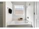 Bright bathroom featuring a soaking tub with a window view, offering a relaxing and spa-like atmosphere at 658 Pamlico Ct., Myrtle Beach, SC 29588