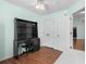 Bedroom with laminate wood flooring, ceiling fan, and a built in dark vanity desk at 658 Pamlico Ct., Myrtle Beach, SC 29588